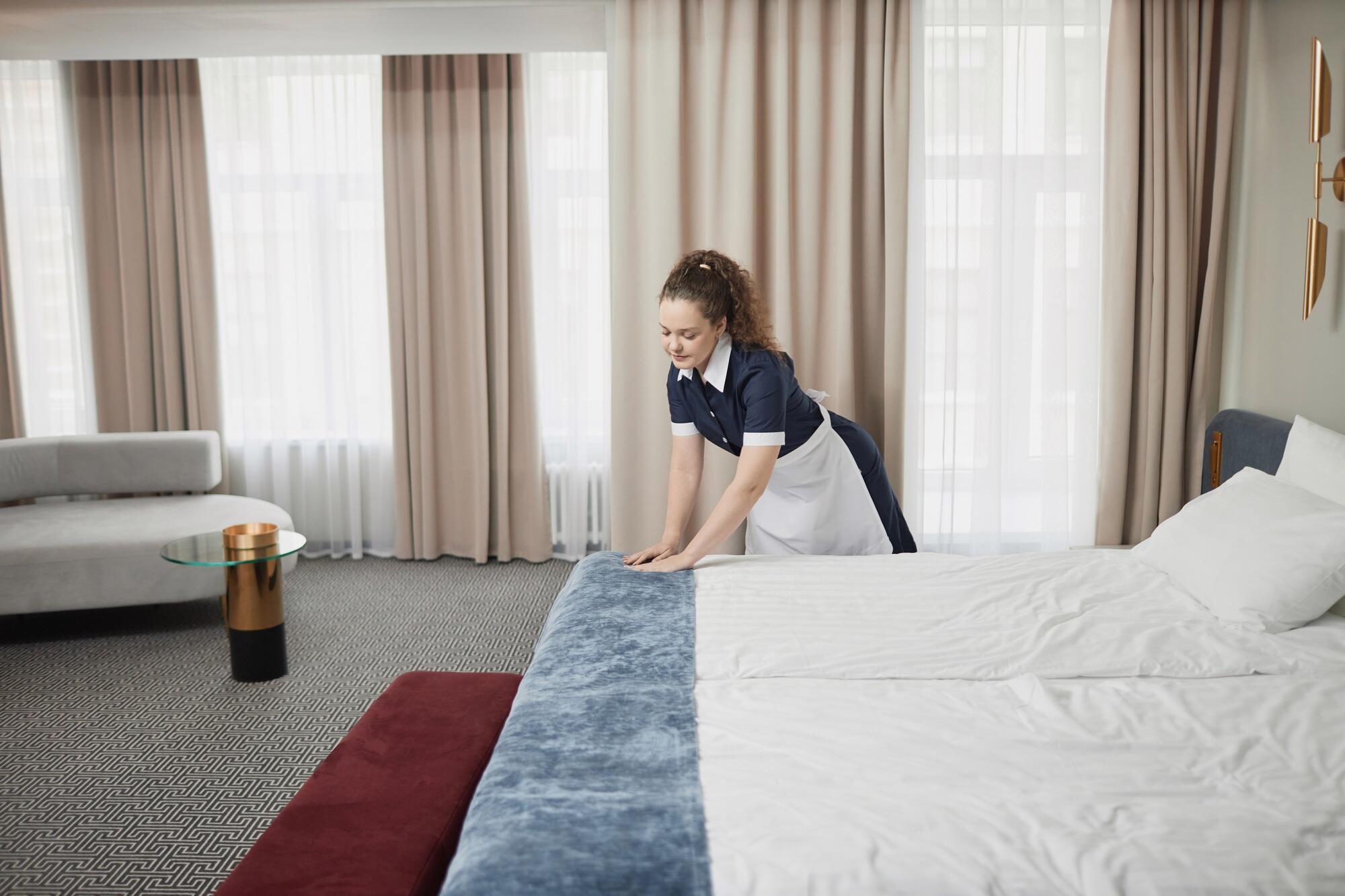 Housekeeper Cleaning Hotel Room