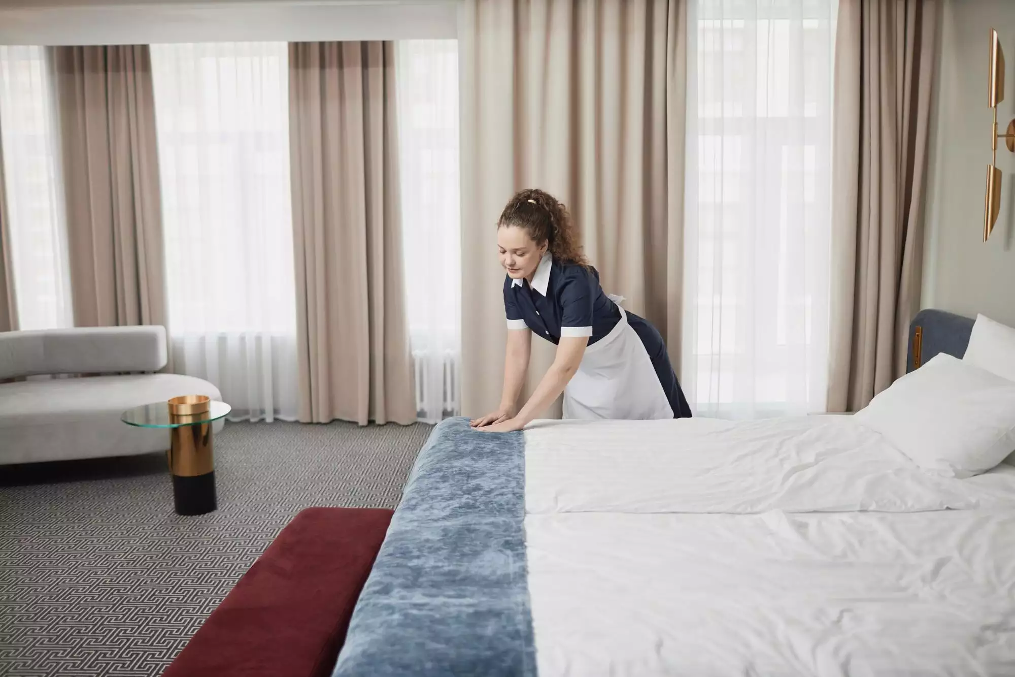 Housekeeper Cleaning Hotel Room