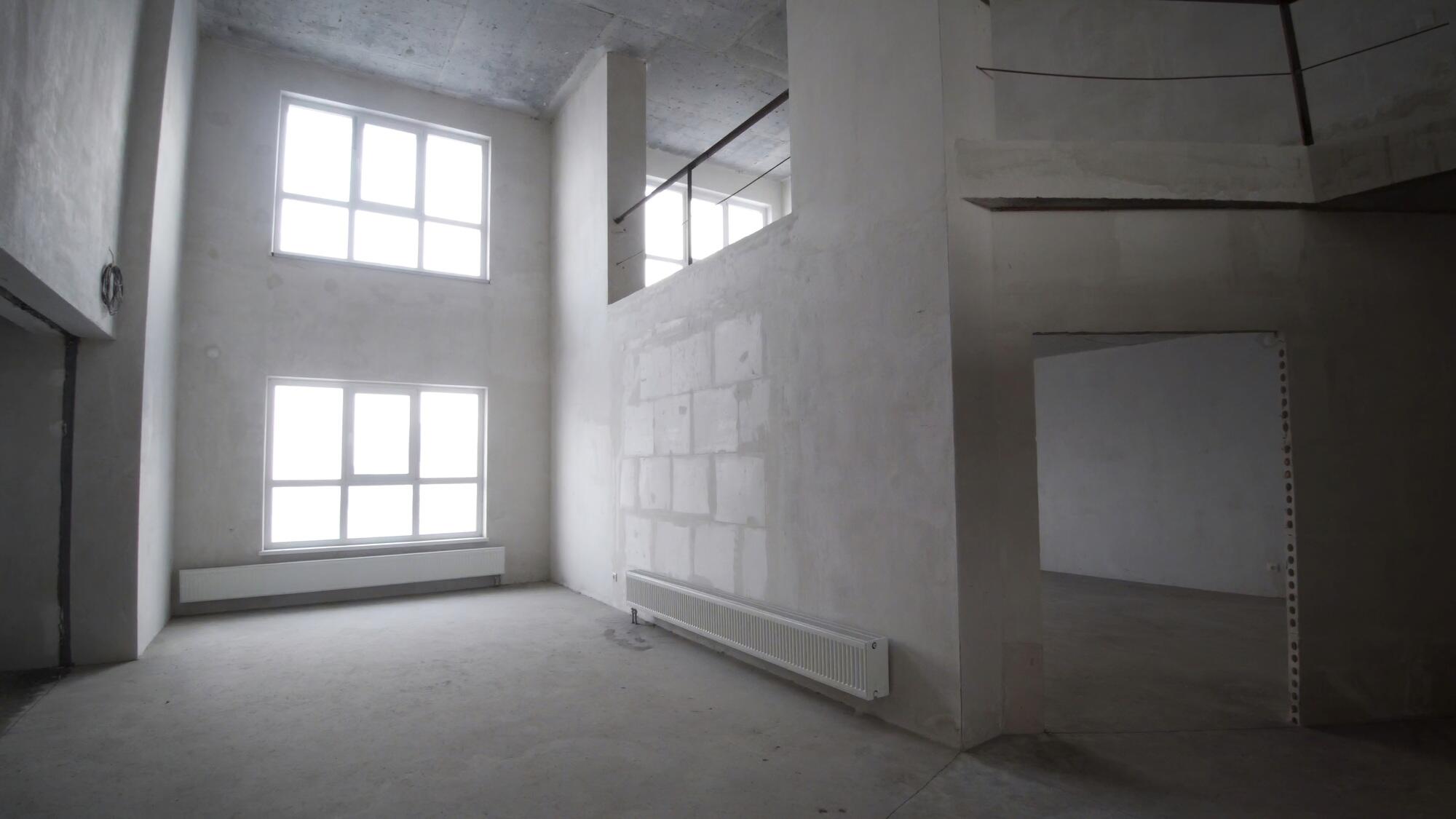 Renovation interior. Clip. Blank white wall with window and concrete floor.