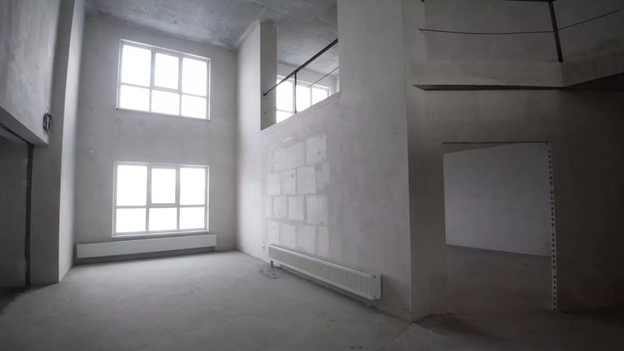 Renovation interior. Clip. Blank white wall with window and concrete floor.